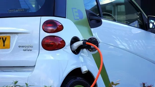 Electric car with a charging cable plugged in