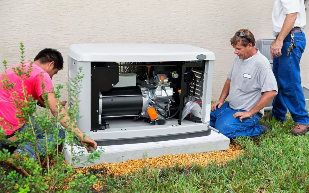 Picture of three electricians installing a home backup generator
